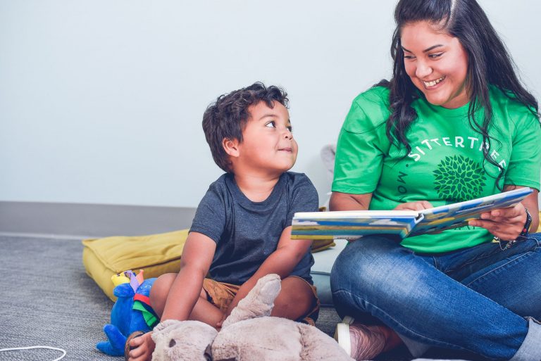 kid and sitter reading