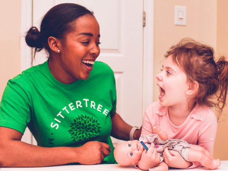 Sitter and young girl playing