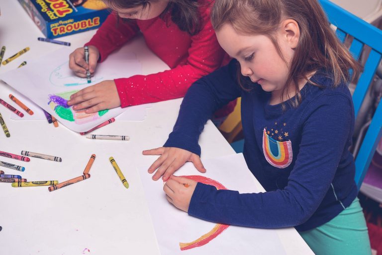 two girls coloring