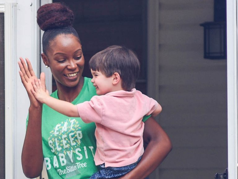 Child and sitter high-five