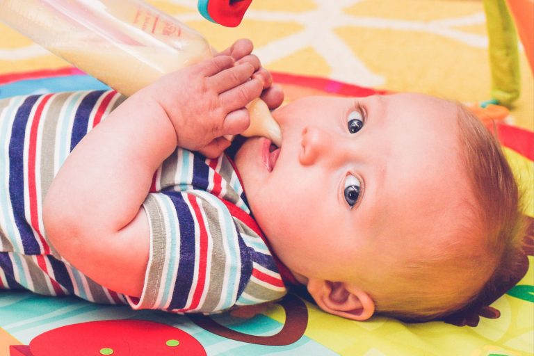 baby holding bottle