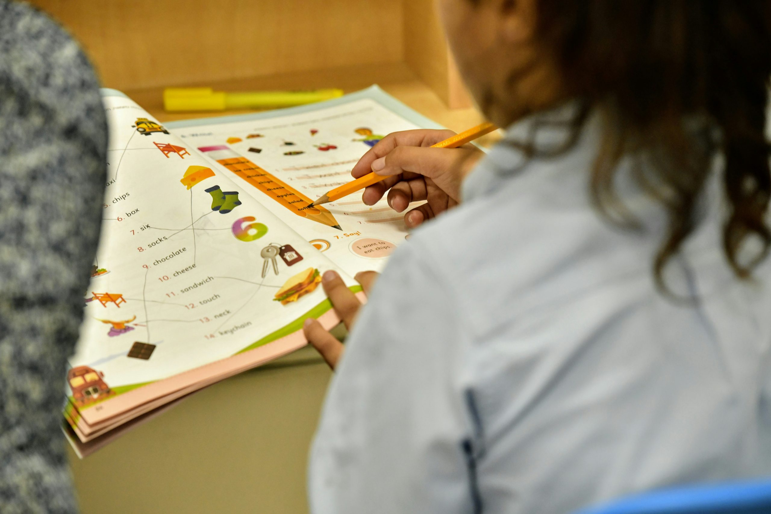 a student completes an educational worksheet created by a teather