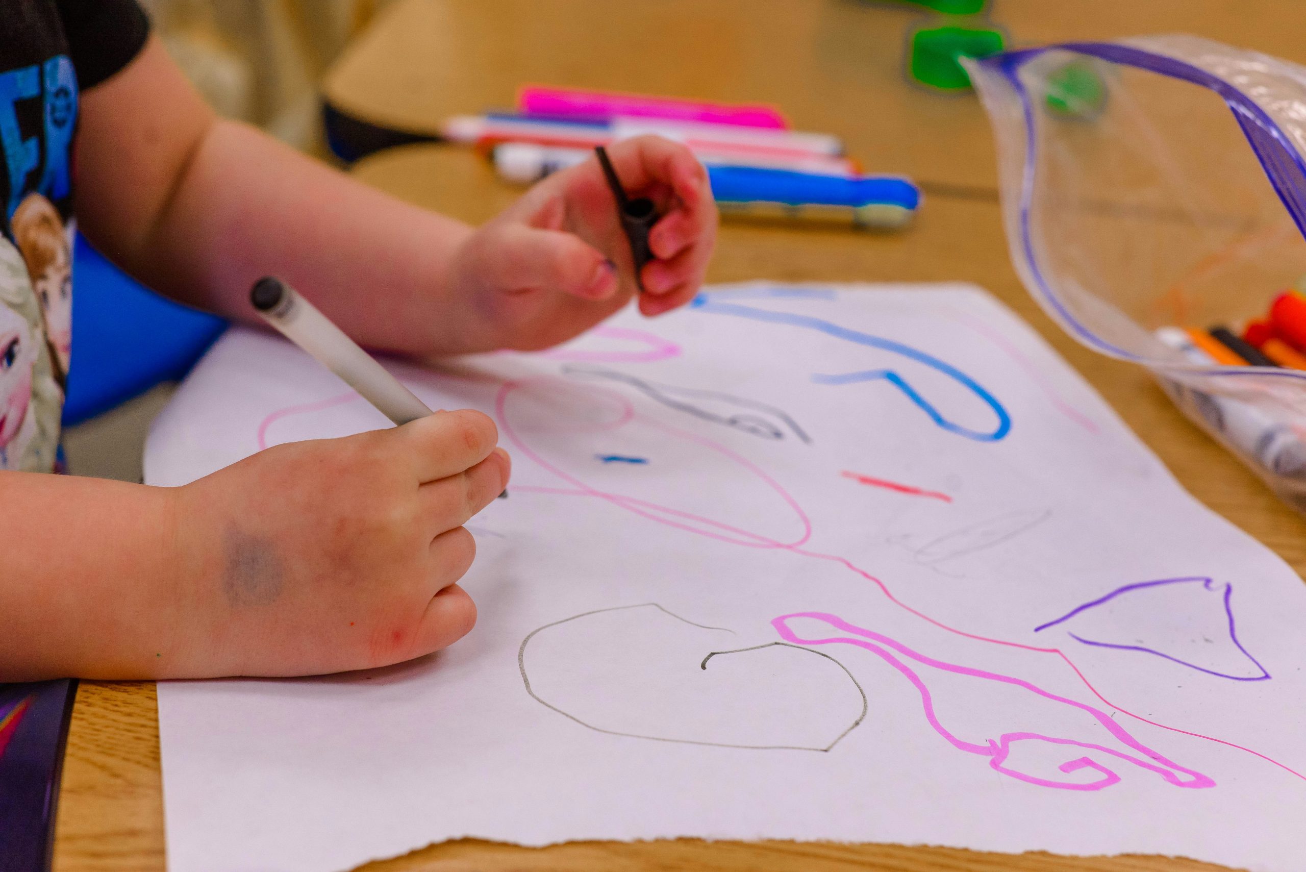 preschoolers color at a childcare center