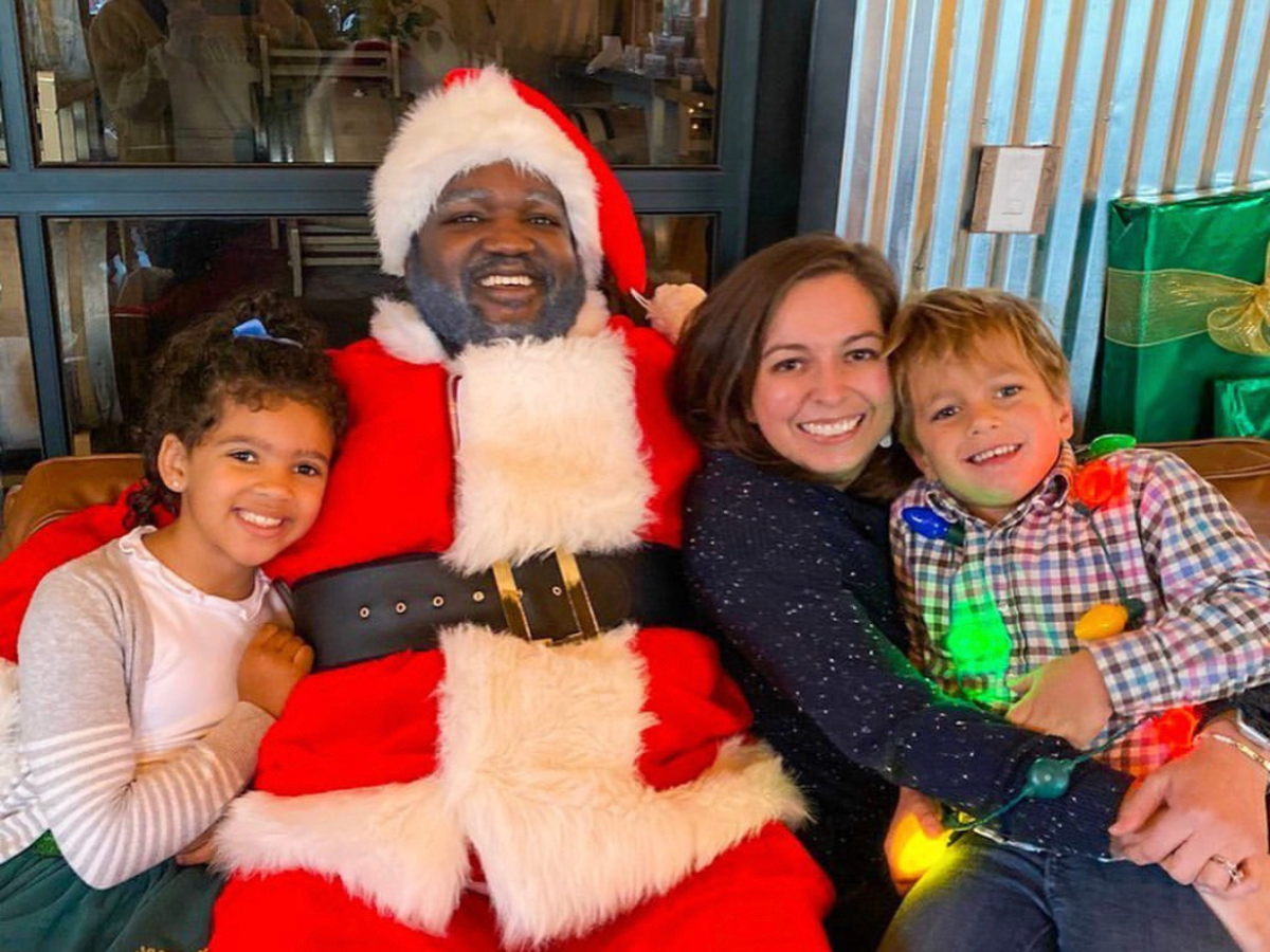 Photos with Santa in Atlanta: family posing with black santa