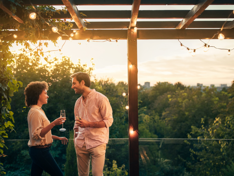 Date Night Ideas in Houston: couple drinking wine on a balcony