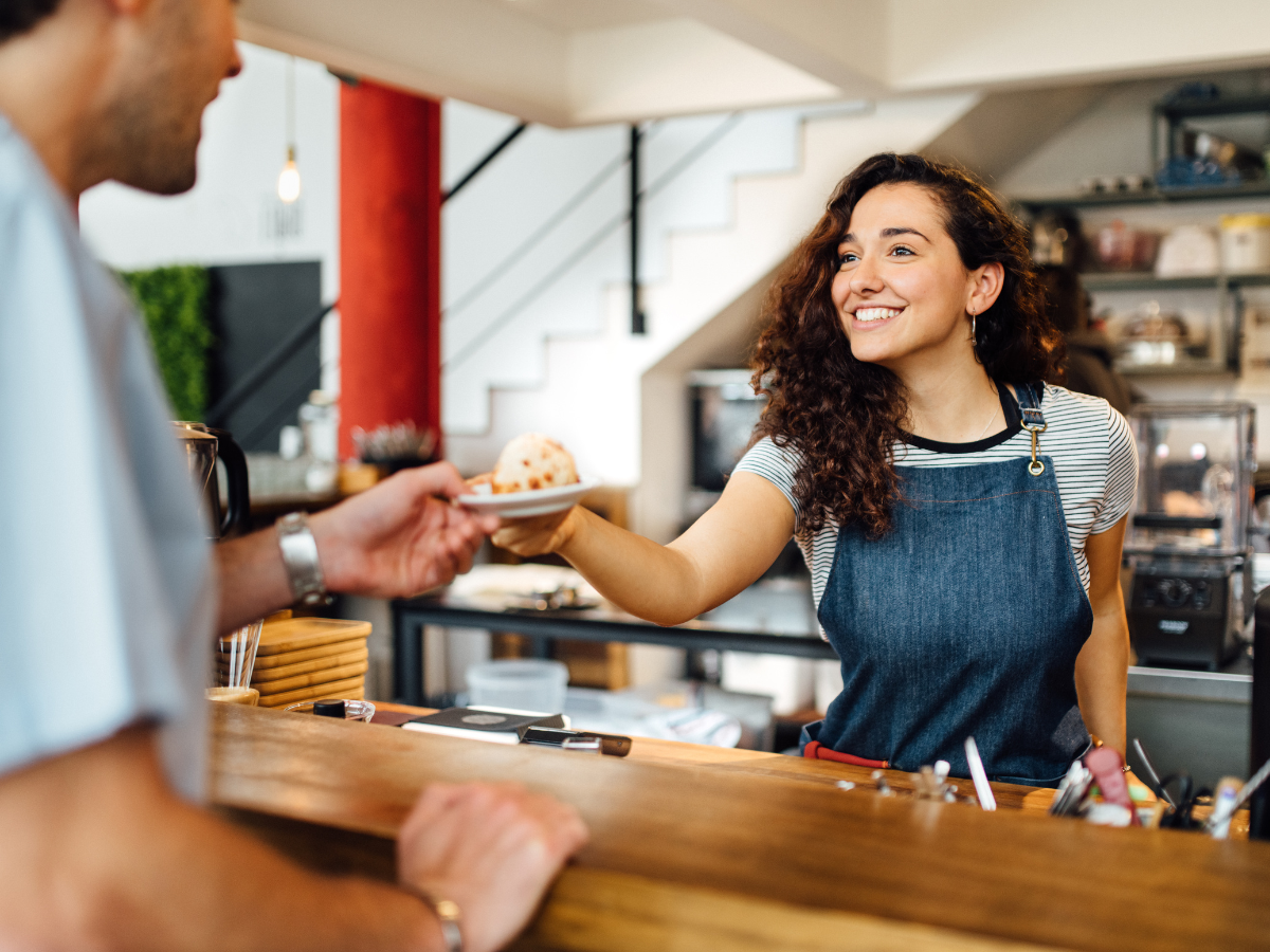 barista handing a customer their order