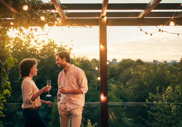 Date Night Ideas in Houston: couple drinking wine on a balcony