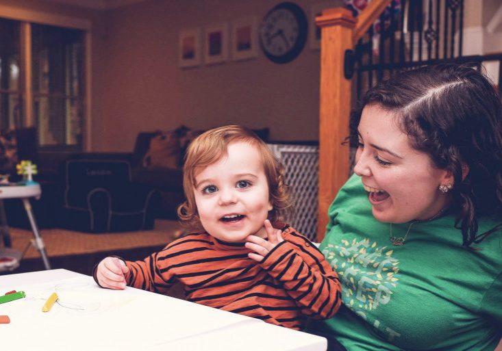 babysitter does a fall craft with a toddler